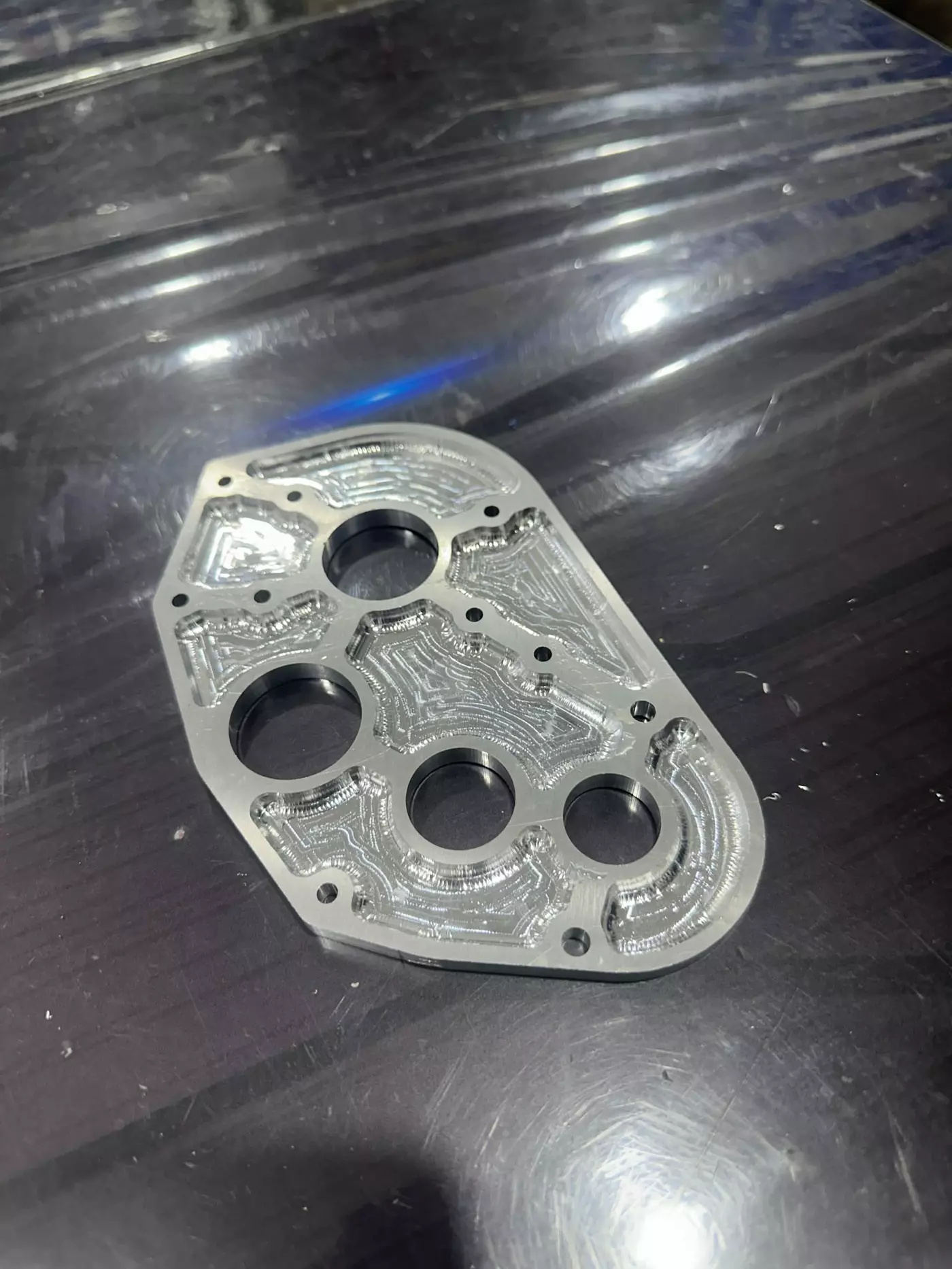 A pocketed aluminum robot plate after CNC machining